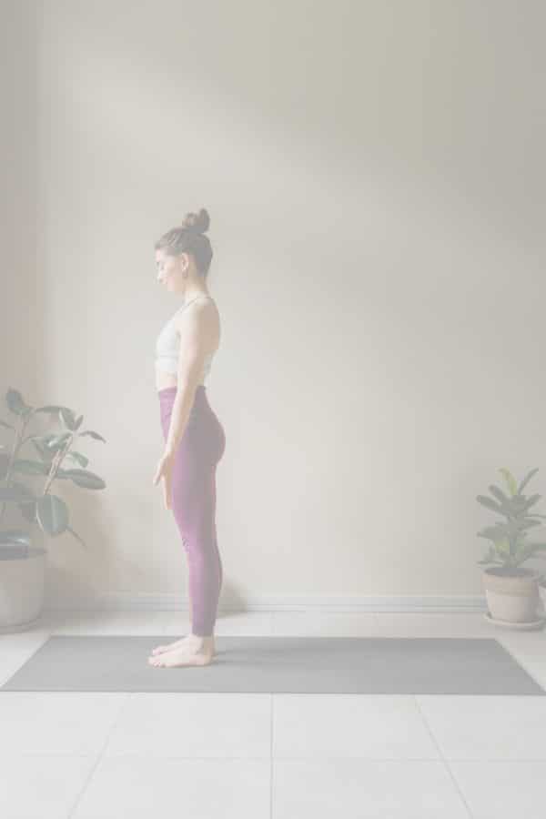 A woman is standing tall in Mountain Pose - yoga to improve balance