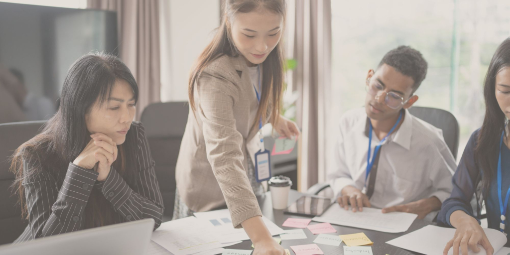 emotional regulation at work a group of professionals around a table demonstrating emotional regulation at work