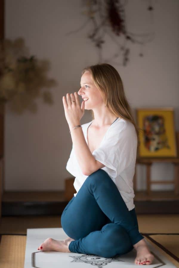 Seated twist beginner yoga pose Young woman doing a seated twist yoga pose