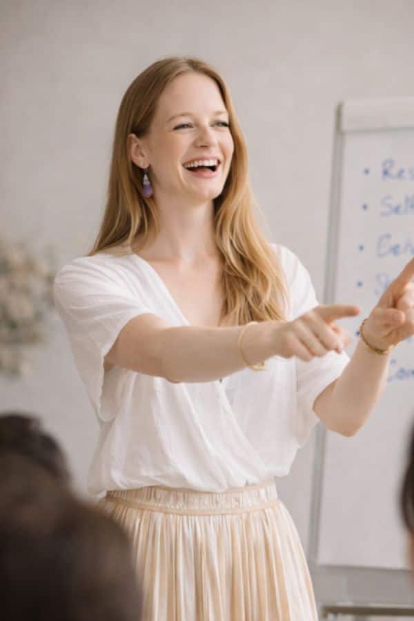 yoga for public speaking woman speaking in front of small audience